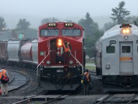 This Friday morning [26 July] in White River, Ontario dawns with rain; but by 0900, the time VIA 186 is set for departure back to Capreol and Sudbury, the steady rain has become a light mist. Once the half dozen passengers had boarded by the former station, the 2 car train – VIA 6250 / VIA 6105 proceeded eastward on the main track a short ways and stopped adjacent to the maintenance-of-way buildings where several CP employees loaded supplies into the baggage car. At the same time eastbound #112 – cp9372 – arrived and stopped for the crew change.  Which train headed east first?? VIA 186, of course!!