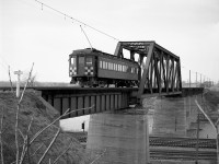Grand River Railway car 842 heads north over the bridge at Waterford, likely a "posed" shot for the riders on the fantrip it was operating on. It's seen crossing on the Lake Erie & Northern Railway line over the New York Central's Canada Southern (CASO) mainlines and TH&B interchange trackage.<br><bR>While the Lake Erie & Northern Railway ceased passenger service in 1955, freight service continued until the track on this bridge was abandoned in 1981. The track was re-laid over this bridge in 1984 for the CPR/Stelco Steel Train, only to be abandoned again a few years later. This bridge is still located here and it has been acquired from CP to be part of the rails to trail project call “The Waterford Heritage Trail” that uses portions of the TH&B and the LE&N right of way as a paved trail for cyclists and others through the area today.  Car 842 was the car used in the above described fan trip organized by several Michigan area railfans. <br><br> Photo taken by Cecil Hommerding, from the collection (Copyright) of Doug Leffler. Substantial caption information provided by George Roth et al with much thanks. <br><br> <i><u>More views from the fantrip:</u></i><br> Stopping at Kitchener: <a href=http://www.railpictures.ca/?attachment_id=10681><b>http://www.railpictures.ca/?attachment_id=10681</b></a><br> Stopping at Paris: <a href=http://www.railpictures.ca/?attachment_id=10356><b>http://www.railpictures.ca/?attachment_id=10356</b></a><br> Visiting the GRR/LE&N Galt Station: <a href=http://www.railpictures.ca/?attachment_id=10502><b>http://www.railpictures.ca/?attachment_id=10502</b></a> <br><br> For more details on Cecil, see <a href=http://www.railpictures.ca/?attachment_id=10297><b>here</b></a>.