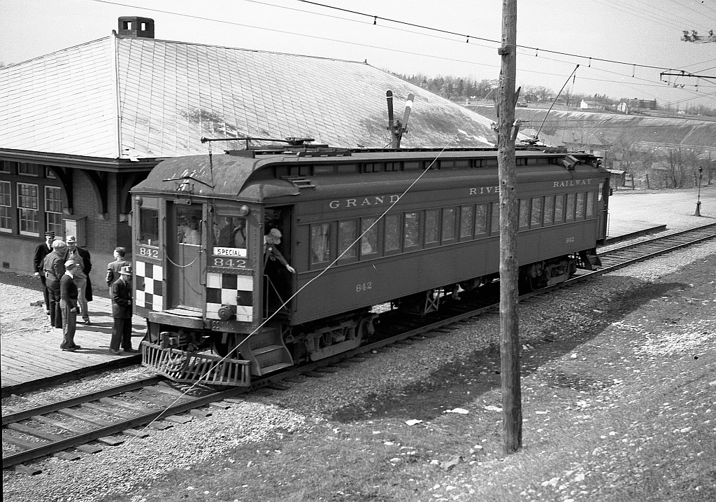 Grand River Railway car 842 stops at Paris Station for a photo view, with riders having a look around, during a fantrip excursion on the line (note the "Special" signage in the windows). The station, located at milepost 13.3 of the line and built during 1916, was demolished during the early 1980s. Passenger service on the GRR ended in 1955, five years after this photo was taken. Photo taken by Cecil Hommerding, from the collection (Copyright) of Doug Leffler. Substantial caption information provided by George Roth et al with much thanks.  More views of the fantrip: 842 crossing the bridge at Waterford: http://www.railpictures.ca/?attachment_id=10357 The fantrip stopping at Kitchener: http://www.railpictures.ca/?attachment_id=10681 842 and 848 MU'ed for the return trip: http://www.railpictures.ca/?attachment_id=10746  For more details on Cecil, see here.