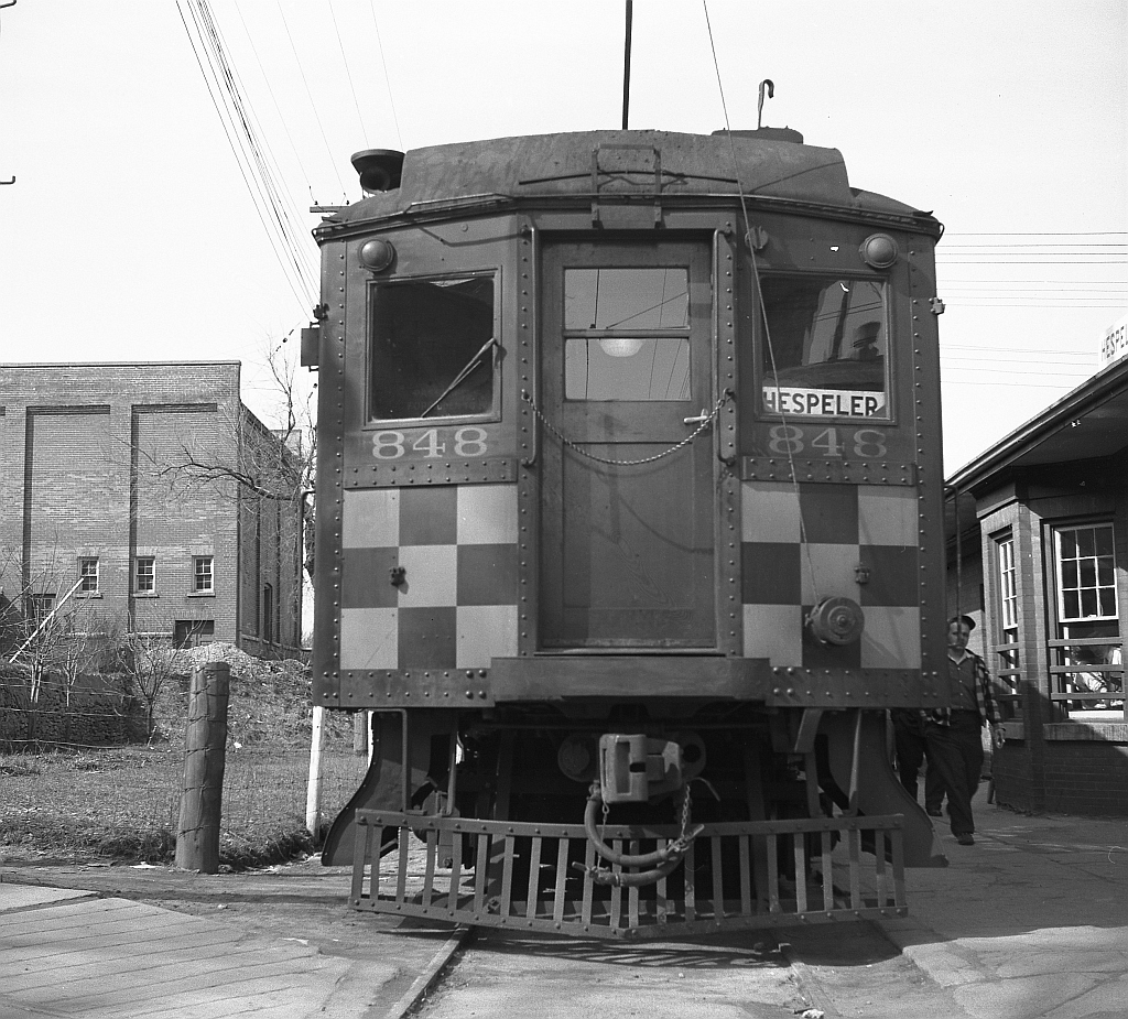 An end view of Grand River Railway car 848 at Hespeler Station. The original Hespeler Station building is believed to have been built just after the service began by the then Galt, Preston & Hespeler Street Railway Company in January 1896. In later years, an express car was left in place in the early afternoon for loading. Passenger service ended in 1955, and the building lasted into the late 1960s after electrical service had ended, before being demolished.  Photo taken by Cecil Hommerding, from the collection (Copyright) of Doug Leffler. Substantial caption information provided by George Roth et al with much thanks.  More views of GRR's passenger operations: 848 and 842 MU'ed for the return trip: http://www.railpictures.ca/?attachment_id=10746 848 at Preston: http://www.railpictures.ca/?attachment_id=10298 864 at Galt Station: http://www.railpictures.ca/?attachment_id=10474  For more details on Cecil, see here.