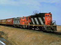 GP9 CN 4225 running long hood forward and F7(A) CN 9167 head east at Ardrossan in March 1987