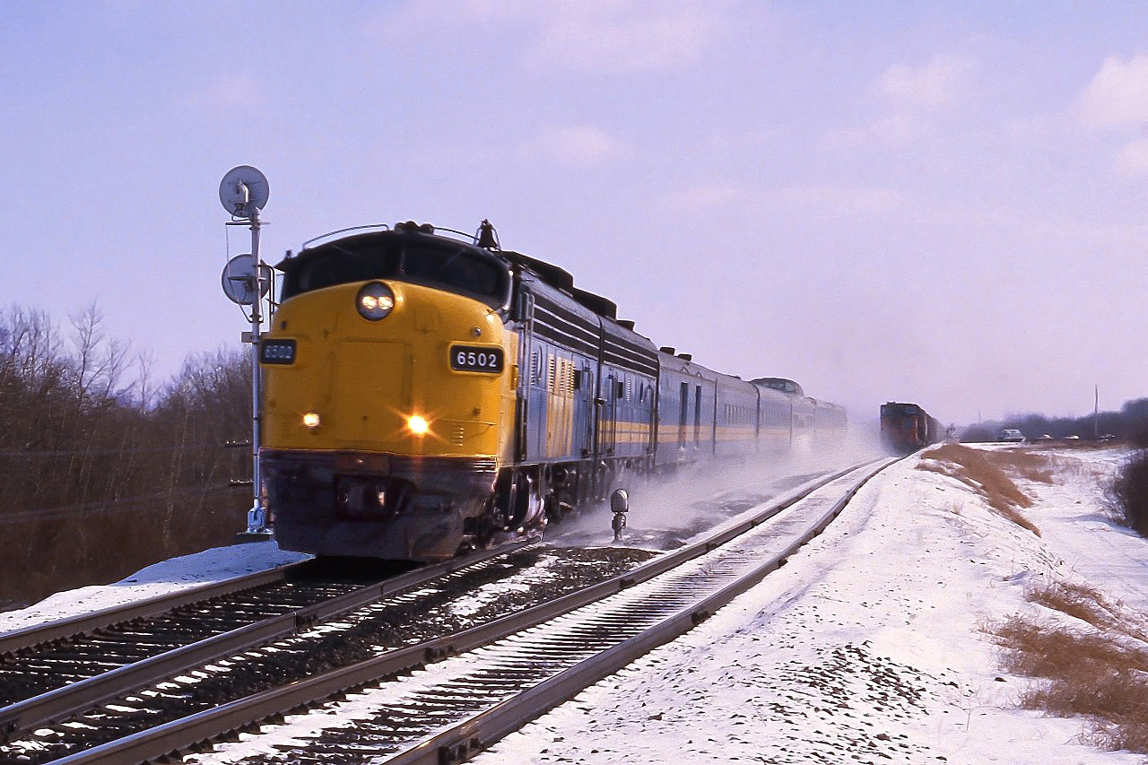 In March 1987 FP9(A) VIA 6502 speeds through Ardrossan with train #3 the Supercontinental kicking up the late spring snow.