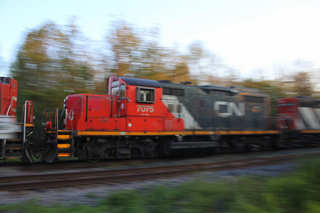 A CN freight carrys 2 GP9RM's behind a pair of SD70M-2's through Glovers Road in Newtonville