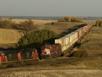 A 10mph CP 103 creeps west along the Wilkie sub, while CN grain empties race east on the Watrous sub at 50mph. 