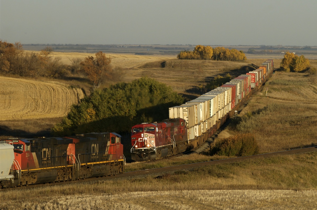 A 10mph CP 103 creeps west along the Wilkie sub, while CN grain empties race east on the Watrous sub at 50mph.