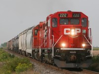 CP T29 heads eastbound through Drake Road, led by CP 2212, a new GP20-ECO unit, and GP38-2 #3015.