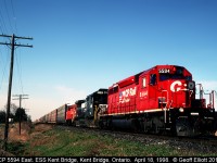 CP 5594 East has an interesting consist as it leads a visitor from Norfolk Southern, in the form of C40-8 #8846, as well as a CP SW1200RSu past the east siding switch at Kent Bridge, Ontario some 15 years ago on a beautiful, sunny April morning.