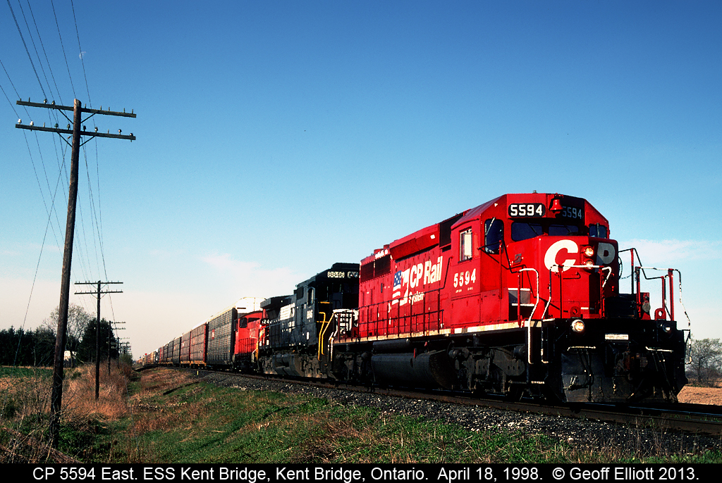 CP 5594 East has an interesting consist as it leads a visitor from Norfolk Southern, in the form of C40-8 #8846, as well as a CP SW1200RSu past the east siding switch at Kent Bridge, Ontario some 15 years ago on a beautiful, sunny April morning.