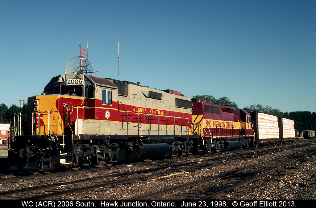 An Algoma Central GP38-2, masquerading as Wisconsin Central #2006, and a WC GP40-2 are the power for today's local out of Hawk Junction and have their 2 car train in tow.  It's early morning in Hawk Junction and this power and train were setoff by the southbound freight last night to do work in and around Hawk Junction today.  I think it is sad how both the CN. and formerly the WC, let the former Algoma Central fall from it's former glory.