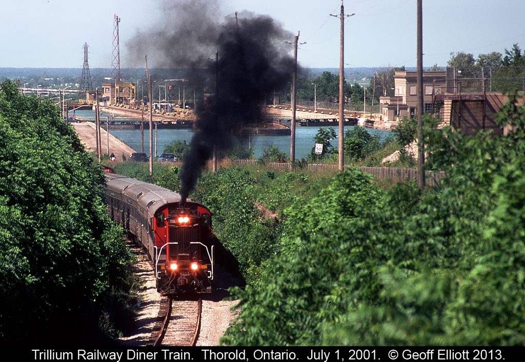 Trillium Railway #110, an ex-CN MLW S13, throttles up to climb the grade on the former CN Thorold Subdivision with their short lived diner train.  I believe that the passenger cars went back to the New York & Lake Erie after this endeavor was abandoned.