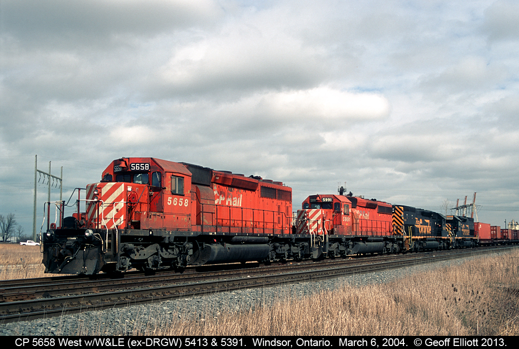 A westbound CP freight sits at Jefferson Ave. in Windsor, Ontario with CP 5658 in command.  For added interest today we have Wheeling and Lake Erie, ex-DRGW obviously, SD40T-2's #5413 and 5391 in the consist.  These Tunnel Motors made a couple trips through Windsor back in 2004, and I was glad I was able to get a 'sucker hole' in the clouds so I could nab a decent shot of them at the time.