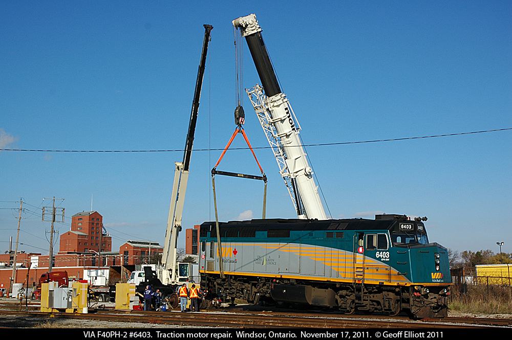 Getting a 'lift' is VIA F40PH-2 #6403 after having a traction motor fail on it's trip down to Windsor in the days prior.  Here a crew is placing a 'dummy' axle in place of the failed traction motor to allow train #76 to tow the unit on the rear of it's train back to Toronto later in the day.  Seems #6403, now #6459, made it into my view finder more often than I realized as I keep finding more and more photos of it.