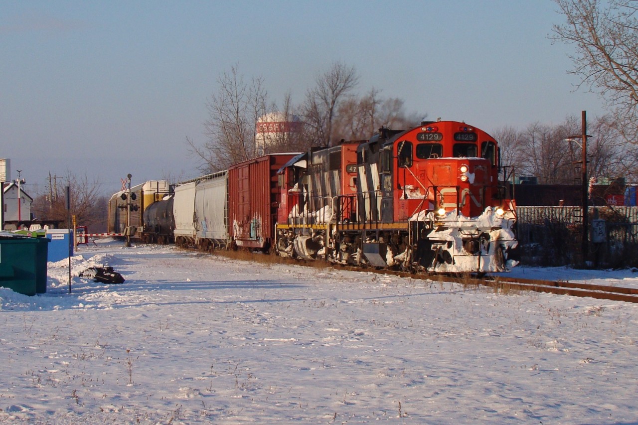 Two elderly EMD 'Geeps' haul the daily London bound freight through Essex on the historic Canada Southern. At the time this power was rare for this train, taking a break from the normal fleet of SD70's and SD75i's that were so common on 438/439. Today however, this is normal power for this train as CN has agreed with VIA to put at least two units on the front in case of mechanical failure, which has happened before. These rails are long gone and CN is now using VIA's Chatham sub to gain access to Windsor.