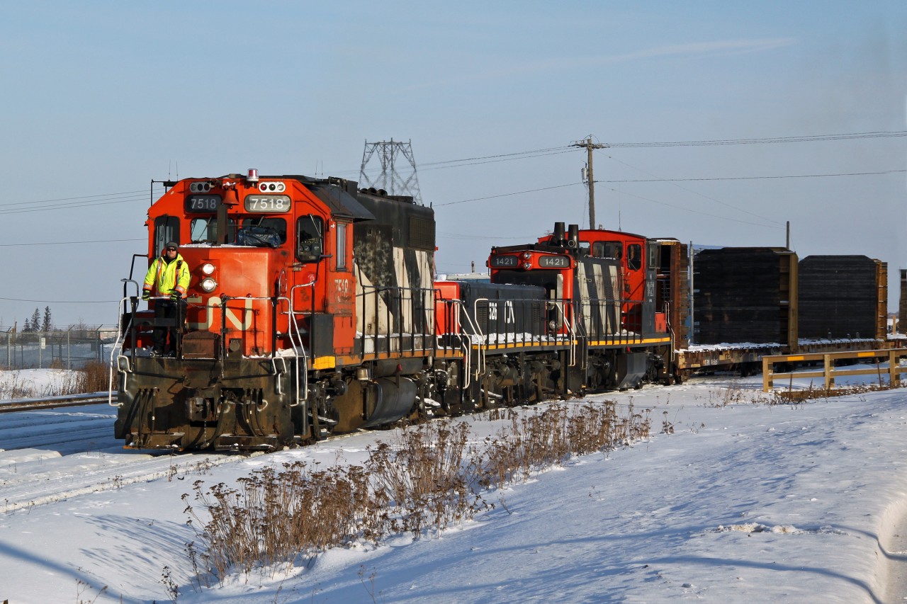 It's a cold job in December. GP38-2 CN 7518, YBU-4m yard slug 526 and GMD1 1421 switching at Clover Bar Yard in East Edmonton.