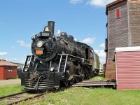 MLW 4-6-0 CN 1392 passes the preserved Gibbons water tower at the Alberta Railway Museum