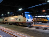 Sitting under the train shed before departure an hour later, Amtrak P42 12 and its train of Amcans (nickname for the round-side Amfleet passenger cars) waits at Toronto's Union Station on VIA #97 "The Maple Leaf". Operating with Amtrak equipment but using VIA crews in Canada, it will depart at 8:30am for Niagara Falls, and after customs inspection will cross the border into New York as Amtrak #64 with an American crew from Amtrak.<br><br>Lurking a few tracks down, VIA 904, another General Electric P42, waits with a ho-hum corridor train alongside it's foreign kin.