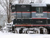 After battling snow drifts and working the line south to Streetsville the previous day, Orangeville Brampton Railway's sole locomotive (a 1957 hi-nose GMD GP9 owned by Cando Contracting) sits on the station track on a snowy winter's morn. Trucks and underframe packed with frozen snow, today is CCGX 1000's day off.