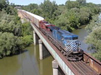 CP 147 with a bluebird in the lead heads west under blue skies.