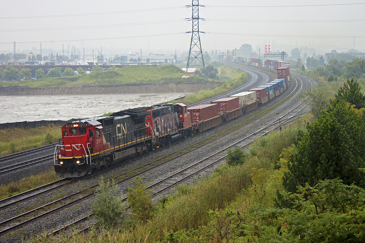 2117 and 4807 haul CN 107 through the pouring rain at Whitby. Thanks for the heads up Dave!