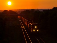 <b>Fleeting Moments of Summer </b> After working Stuart Street Yard and waiting for some congestion around Jordan to clear up, CN 330 charges out of Hamilton with CN 8897 and BCOL 4646 doing the honours. This wonderful sunset brought an excellent day trackside to a close.