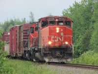   The daily local from Campbellton NB to Bathurst passes the VIA depot at Jacquet River.  CN 9418 and CN 7015 climb out of the river basin and will work up the tracks at Belledune (CHALEUR LUMBER).