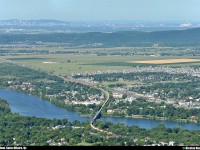 With a very long train, CN 120 pass over the Richelieu river. In the same picture, you can see Montreal downtown, the ''Mont-Royal'', the Olympic stadium of Montreal, a part of ''Mont-Saint-Bruno'' and few cities like Montreal, Saint-Basile-le-Grand, McMasterville, Beloeil, etc. The shot was taken on the top of the ''Mont-Saint-Hilaire'' with an elevation of 415m. 