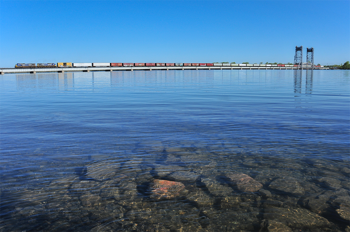 With 35 cars behind the 8000 H.P., CN 327/CSX Q620 crosses the seaway bridge over the Beauharnois Canal.