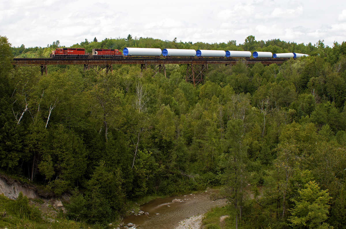 After rotting in Smiths Falls for three days, this train of windmill tower sections finally got rolling across the Belleville sub today. Here it is about to pass the last siding before Toronto Yard, where it will tie down for the rest of the day.