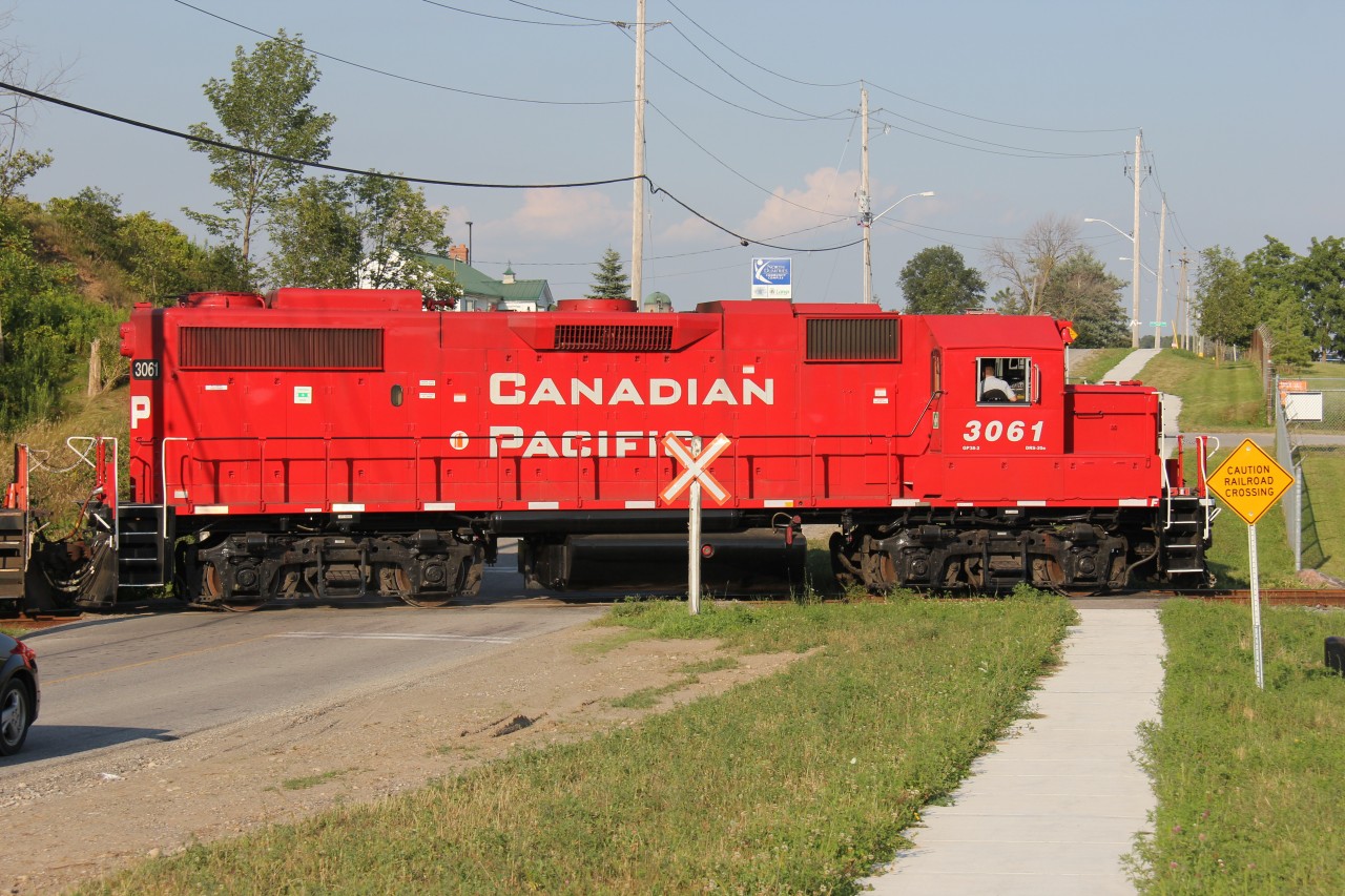 A CP local backs up on the Ayr Pit Spur, crossing Greenfield Rd., on the north end of Ayr. Power was CP 3061, CP 8248 and CP 3062. The paint still looks fresh on this unit as it gleams in the early evening sun of a warm summer evening.