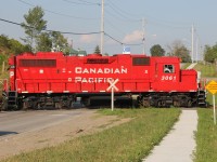 A CP local backs up on the Ayr Pit Spur, crossing Greenfield Rd., on the north end of Ayr. Power was CP 3061, CP 8248 and CP 3062. The paint still looks fresh on this unit as it gleams in the early evening sun of a warm summer evening.