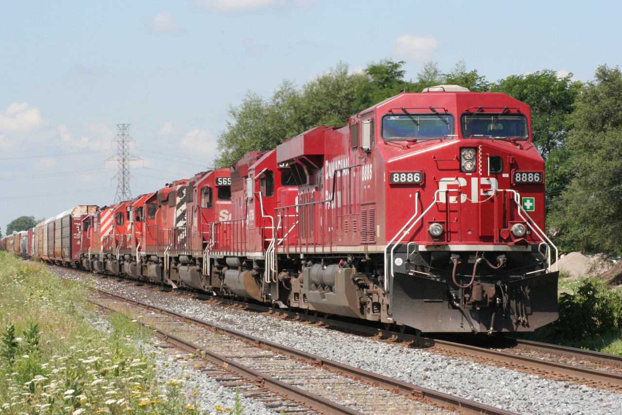 A CP eastbound with 8 locomotives is just about to depart Orrs Lake siding for points east. Note that all trailing locomotives are EMD products, including a Red Barn. The train is just about to cross Edworthy Sideroad just west of Cambridge.