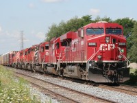 A CP eastbound with 8 locomotives is just about to depart Orrs Lake siding for points east. Note that all trailing locomotives are EMD products, including a Red Barn. The train is just about to cross Edworthy Sideroad just west of Cambridge. 