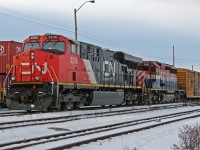 Heading East out of Edmonton, seen between Walker Yard and East Junction, are ES44DC CN 2236 and BCOL SD40-2 766 in "hockey stick" livery