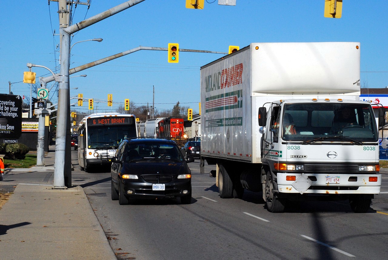 CN 580 is southbound on the Burford Spur paralleling lunch hour traffic on Clarence Street.