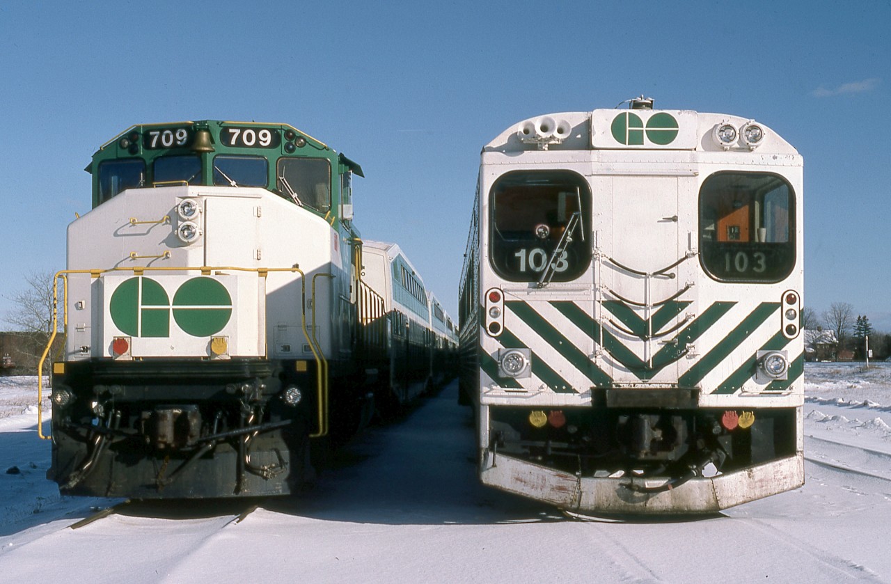 A near Christmas Saturday afternoon finds opposing ends of weekend stored GO Transit push-pull commuter equipment at CP Guelph Junction. GO GP40-2(W) 709 was built by GMD London in 1975. Following the introduction of F59PH’s she would be conveyed to Canadian National in 1991 and renumbered to CN 9676. The former GO unit continues in service to this day, currently in the province of Alberta. Note the brass bell above the cab windows. Cab control car 103 was constructed by Hawker Siddeley in 1967. Ultimately displaced by 200 series double deck cab cars, the remaining 100 series cars were sold the province of Quebec in 1994.
