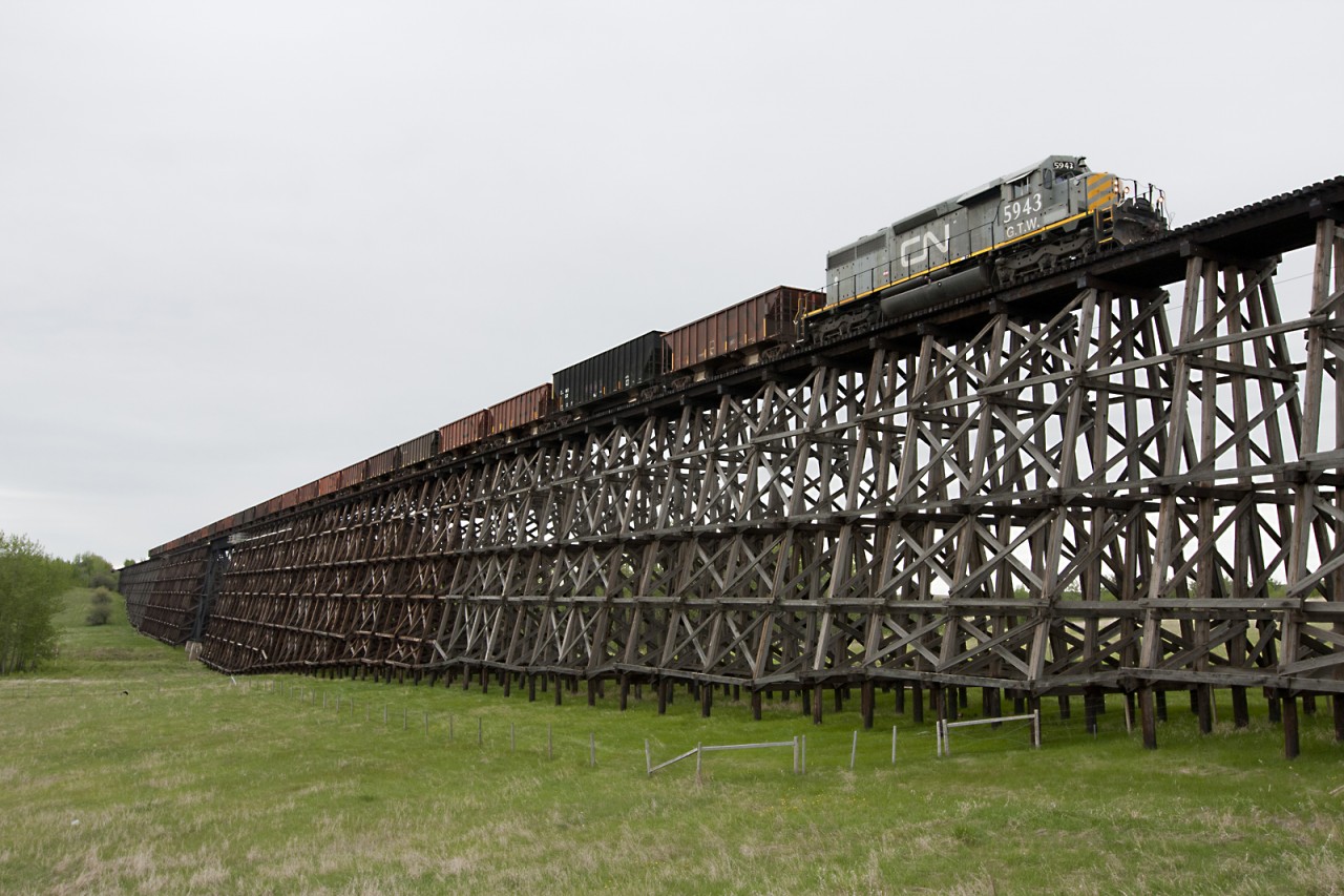 GTW SD40-3 #5943 pulls a ballast train over the impressive Paddle River Trestle