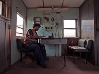 The conductor on the Goderich bound way freight looks over his paper work for the day as his engineer and brakeman fetch the head end portion of the train.