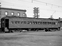 Visible here is a broadside image of Grand River Railway car 842, the fantrip's car, taken at the GRR - LE&N Galt Main St Station. <br><br> As mentioned in a previous photo, the brick and stone station was built during the summer of 1922 and opened for passenger service on December 23rd, 1923. The location was on east Main Street, opposite the then standing CPR Freight shed. The location, thus allowed both railways to operate their passenger rail equipment interchangeably as electrical voltage was made consistent between both railways on December 4th 1921. The location became Mile Post Zero for both railways. The GRR to the north, the LE&N to the south. Later it became a loading point also for the bus service of Canadian Pacific Transport that served Preston, Blair and Kitchener. The building was demolished in the summer of 1956. <br><br> Car 842 was part of eight steel passenger cars built by the Preston Car & Coach Company in 1921 when the GRR upgraded from 1500 to 600 volts. In the years following the end of passenger service in 1955, most were eventually scrapped. <br><br> Photo taken by Cecil Hommerding, from the collection (Copyright) of Doug Leffler. Substantial caption information provided by George Roth et al with much thanks. Some car details from the late W.E. Miller's <a href=http://www.trainweb.org/elso/grr.htm><b>Grand River Railway site</b></a> <br><br> <i><u>Other photos from that day:</u></i><br> The GRR-LE&N Galt Station: <a href=http://www.railpictures.ca/?attachment_id=10502><b>http://www.railpictures.ca/?attachment_id=10502</b></a><br> Car 864 at Galt Station: <a href=http://www.railpictures.ca/?attachment_id=10412><b>http://www.railpictures.ca/?attachment_id=10412</b></a><br> Fantrip car 842 at Kitchener: <a href=http://www.railpictures.ca/?attachment_id=10681><b>http://www.railpictures.ca/?attachment_id=10681</b></a><br> <br> For more details on Cecil, see <a href=http://www.railpictures.ca/?attachment_id=10297><b>here</b></a>.