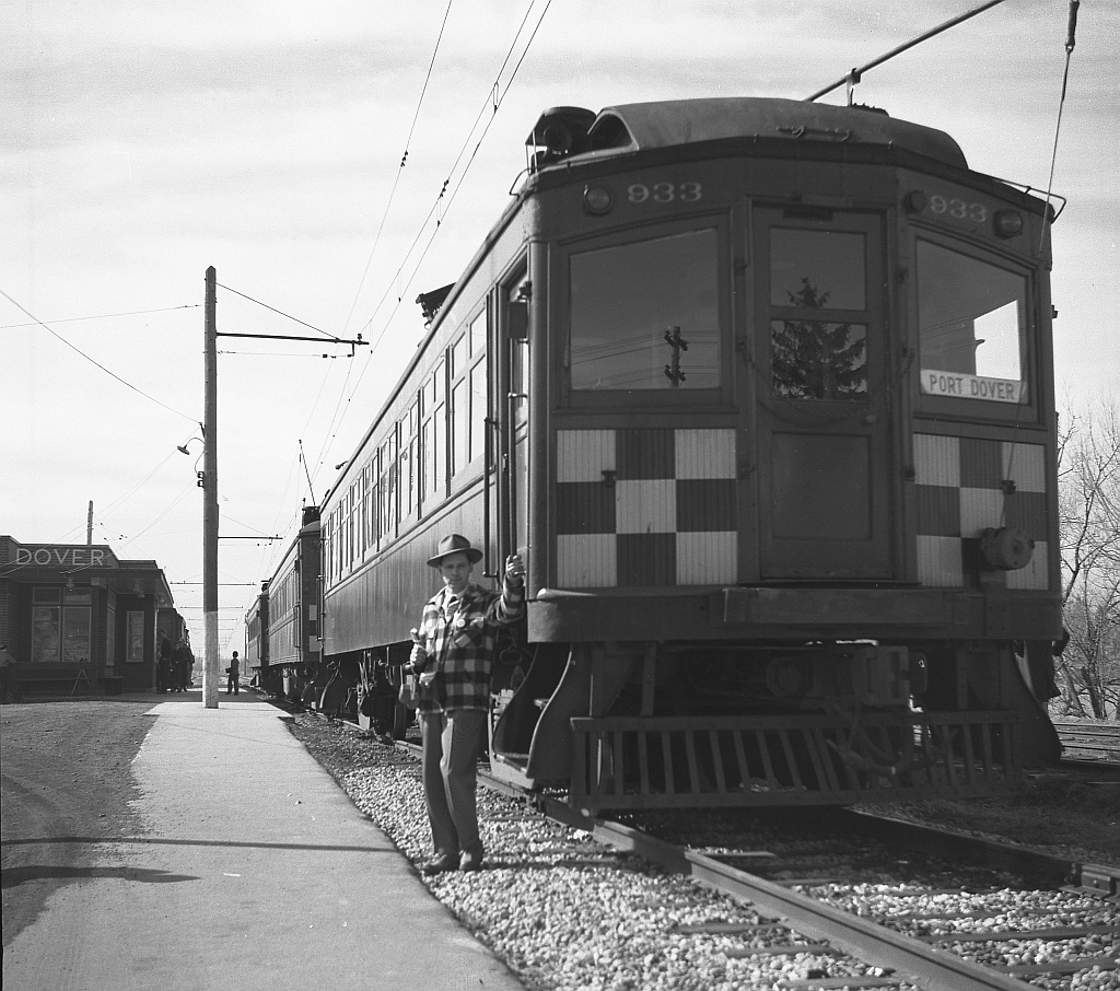 Lake Erie and Northern car 933 is shown coupled to two other cars at Port Dover station. The gentleman posed by 933 is a good friend of Mr. Hommerding, Jim Findlay of Hudson, Michigan, who attended the fantrip with Cecil and is seen snacking on an ice cream bar. Car 933 would be a “protect service” car that was kept at the Port Dover Station to cover any needs of service. Port Dover was the south end of the LE&N line that started at the GRR-LE&N Galt Main Street station and ran 51 miles south to Port Dover. The station was built in 1947 to a CPR Station Plan, at Chapman and Main Street, Milepost 51.0 of the LE&N. It was sold in 1965 to CN, who later sold it to the local town. Today it is leased to a private firm, owned by the Norfolk Region and still exists today (though not like it looks in this 1950 photo!).  This series of photos were taken by a now-deceased friend, William Cecil Hommerding (who passed away in 1983). Another mutual (deceased) friend, Jim Findlay of Hudson, Michigan (pictured) accompanied Cecil on the trip. The Buffalo, Rochester and Syracuse chapters of the NHRS did each run several one day trips over the entire near 69 mile GRR-LE&N line around when these photos were taken, always on a Sunday. This particular trip was by a group from Michigan who held a one day, full length of the line trip on April 30th 1950 using GRR car 842, as pictured in many of Cecil's images. Although both Cecil and Jim are now deceased, their photos live on!  (* Editors note: we would like to thank Doug Leffler for sharing these excellent historical photographs of Cecil's with us, and George Roth for helping interpret much of the historical and contextual information depicted in these photos.)  Other photos from the fantrip: Car 842 crossing the bridge at Waterford: http://www.railpictures.ca/?attachment_id=10357 The fantrip at Kitchener: http://www.railpictures.ca/?attachment_id=10681 The GRR's Preston Shops: http://www.railpictures.ca/?attachment_id=10413  For more details on Cecil, see here.