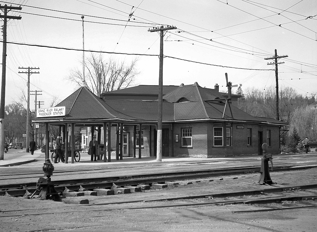 The Grand River Railway's Preston Junction Station.  This station was built in the late 1890's as a passenger loading point between the then three directions of the Galt, Preston & Hespeler passenger cars, and the new direction to Berlin of the Preston & Berlin Railway. Later it became a loading point also for the bus service of Canadian Pacific Transport. The canopy was removed after rail passenger service ended in 1955. Freight crews used the waiting room for lockers and storage, and the back room for signing in and off of assignments until all electrical rail services ceased on October 1st, 1961. The building was demolished in September 1962.   Photo taken by Cecil Hommerding, from the collection (Copyright) of Doug Leffler. Substantial caption information provided by George Roth et al with much thanks.  Other photos at Preston: Passenger car passing through Preston: http://www.railpictures.ca/?attachment_id=10942 GRR's Preston Shops: http://www.railpictures.ca/?attachment_id=10413 Car 848 at Preston: http://www.railpictures.ca/?attachment_id=10298   For more details on Cecil, see here.