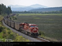 Under a very hazy sky, CP8818 accompanied by mid-train DPU 9373 and rear DPU 8708 are seen having just left Ft Steele on the Windermere Sub with loaded coal heading north along Bummers Flats bound for Roberts Bank on the coast.