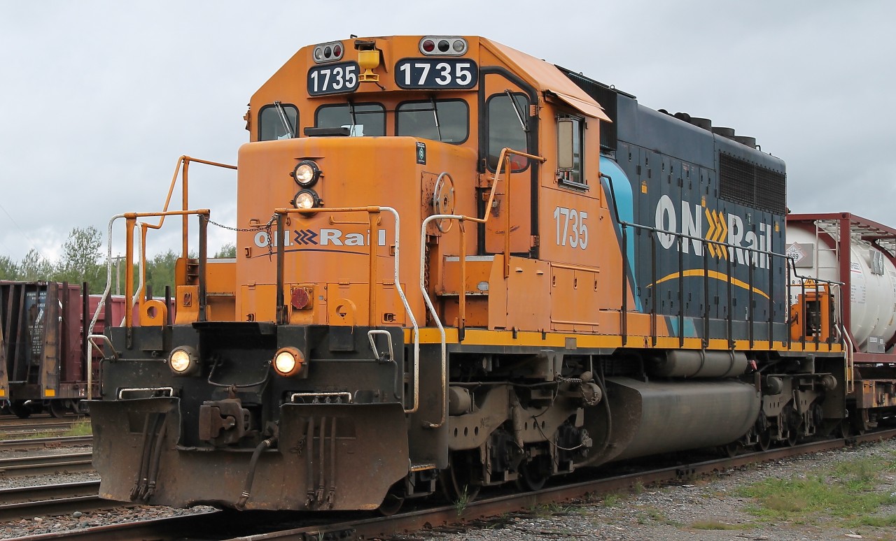 ONT 1735 leads a two car cyanide train through Englehart.  The train is heading North for use in mining.