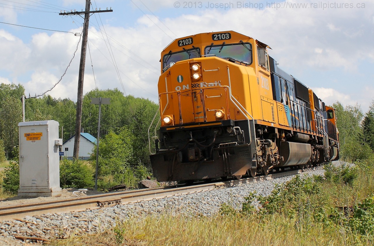 ONR 211 blasts through Boston Creek with ONT 2103 and ONT 2101 in charge of a large train.