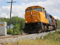 ONR 211 blasts through Boston Creek with ONT 2103 and ONT 2101 in charge of a large train.