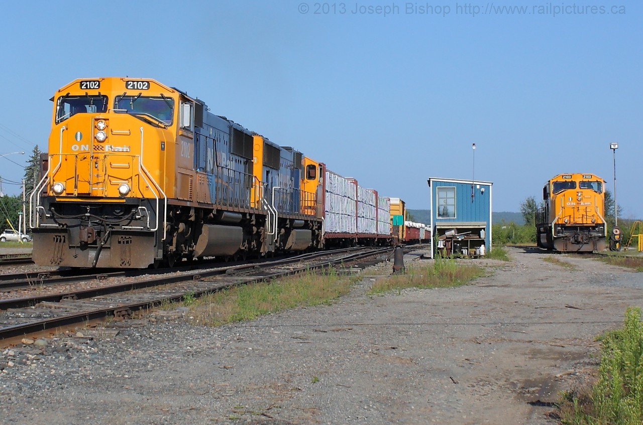 ONT 2012 and ONT 2101 notch up getting Southbound train 214 under way out of Englehart as ONT 2103 watches from the RIP track at the shops.