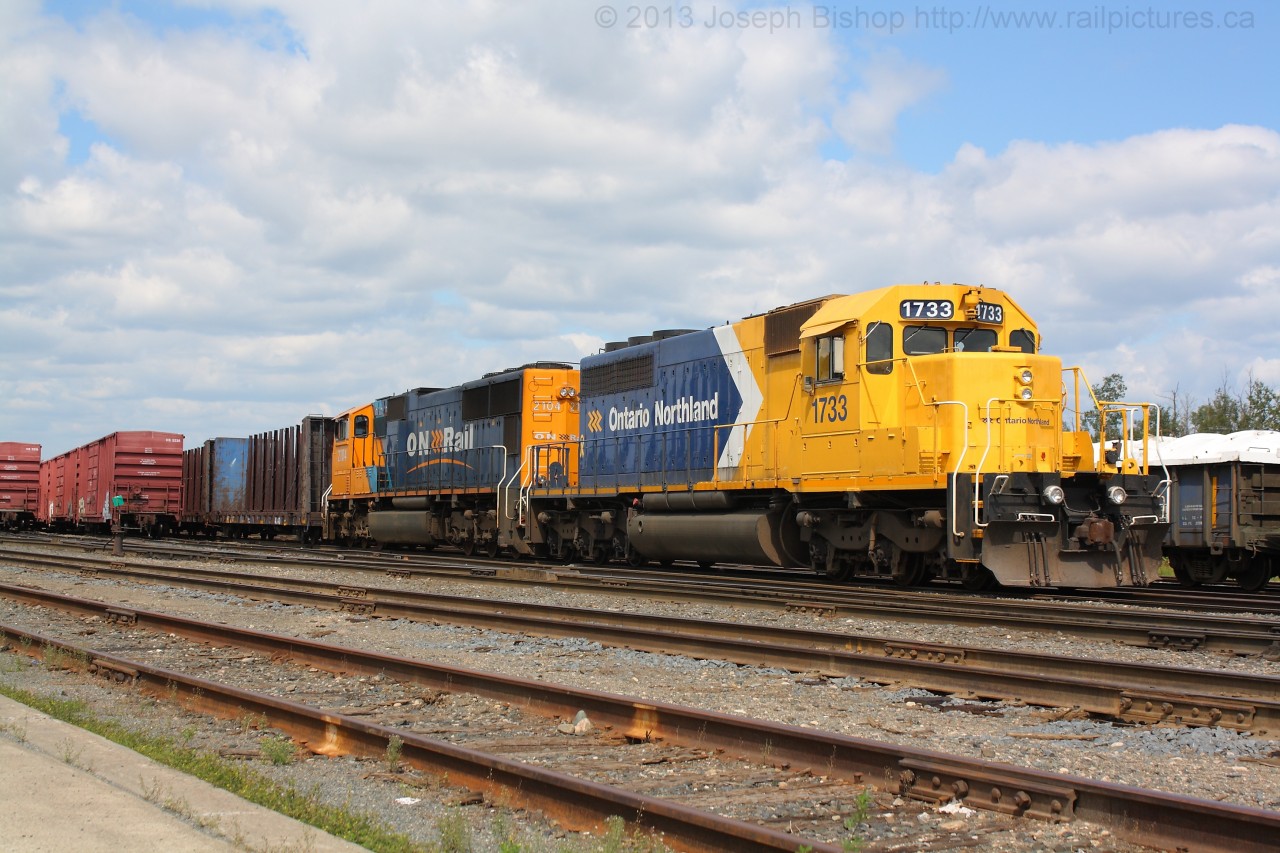 ONT 1733 and ONT 2104 sit in the yard in Englehart awaiting their call for duty on a Northbound freight.  1733 is wearing the most recent ONR paint scheme and looks a little different from when I last saw her.  Since last summer 1733 was involved in a grade crossing accident and its classification lights above its number boards have been removed.