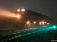 On an extremely foggy evening, Via #2 has come to a brief stop at Flanigans well a switch is thrown, so Canadas premier passenger train can be routed through CNs Thornton Yard. 