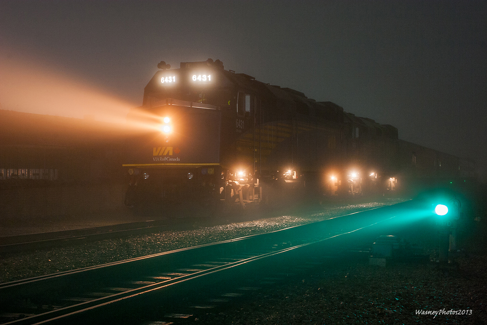 On an extremely foggy evening, Via #2 has come to a brief stop at Flanigans well a switch is thrown, so Canadas premier passenger train can be routed through CNs Thornton Yard.