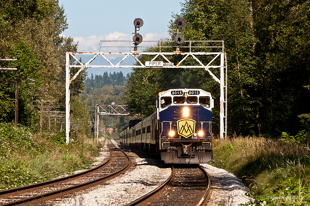 The westbound Rocky Mountaineer heads northbound through the signal bridges at Piper on a sunny afternoon, as the train gets close to its destination of Vancouver, BC.