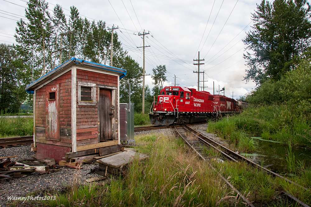 Departing the Clayburn diamond in Abbotsford, BC, CPs Sumas Turn passes over the diamond shared with Southern Railway of BC. To the left is the hut that was used to activate the semaphore signals that have been decommissioned. Since this image was taken the hut has been removed and has been donated to the Fraser Valley Heritage Railway that operates the Interuban between Cloverdale, BC and Sullivan.